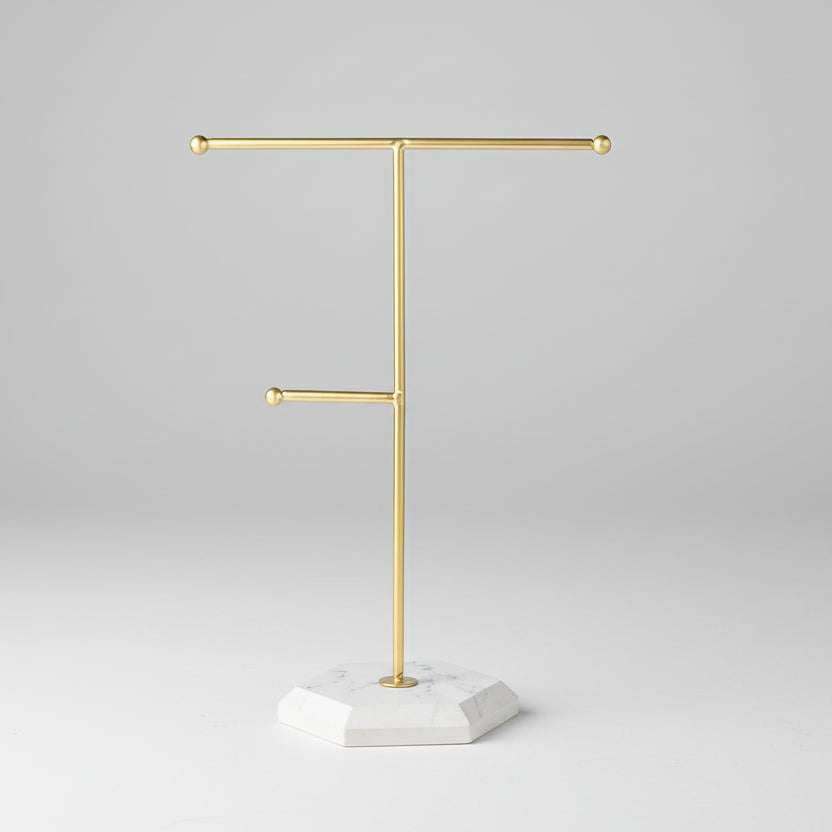 Gold jewelry stand with measurements on a white background