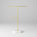 Gold jewelry stand with measurements on a white background