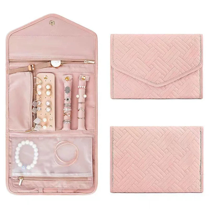 Pink jewelry travel case with accessories and matching pouches on a white background