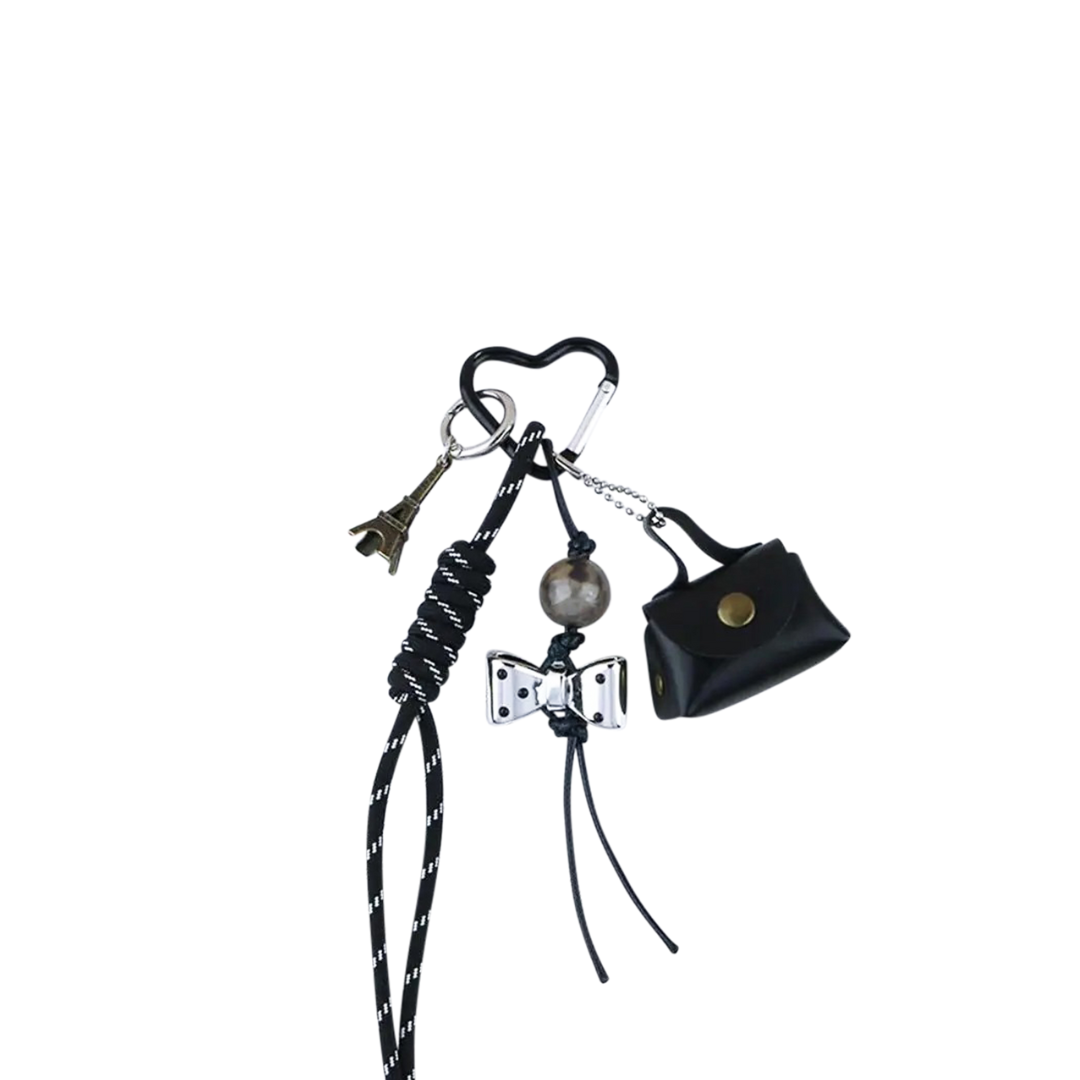 Black genuine leather coin purse bag charm with snap closure and fold-over flap. Functional mini pouch keychain.