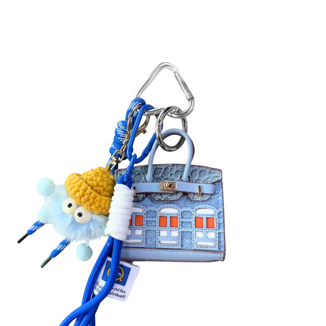 Sky Blue leather structured mini bag charm shaped like a house, featuring decorative window panels and a top handle.