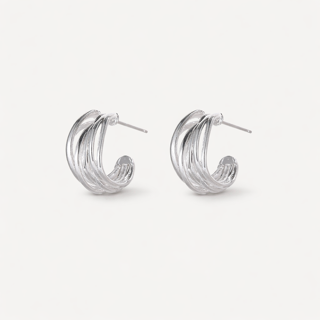 Pair of silver hoop earrings on a white background