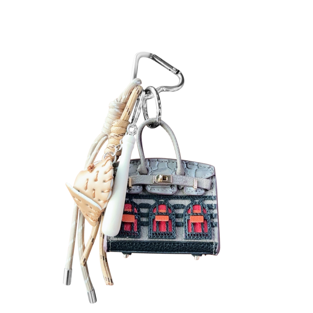 Mini Bag Charm in gray handbag keychain with decorative house on a white background.