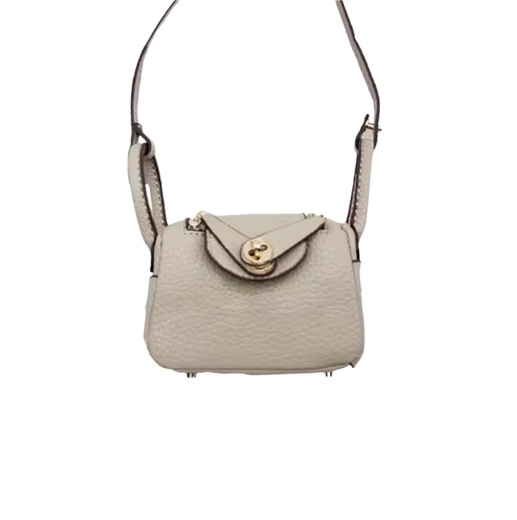 Khaki textured leather mini crossbody bag charm with gold-tone twist-lock closure and thin shoulder strap. Keychain and handbag accessory.