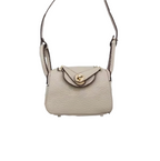 Khaki textured leather mini crossbody bag charm with gold-tone twist-lock closure and thin shoulder strap. Keychain and handbag accessory.