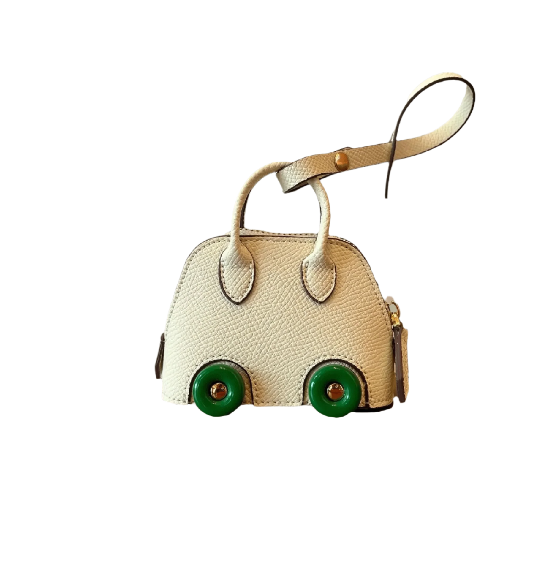 Small cream-colored mini purse with green wheels on a white background