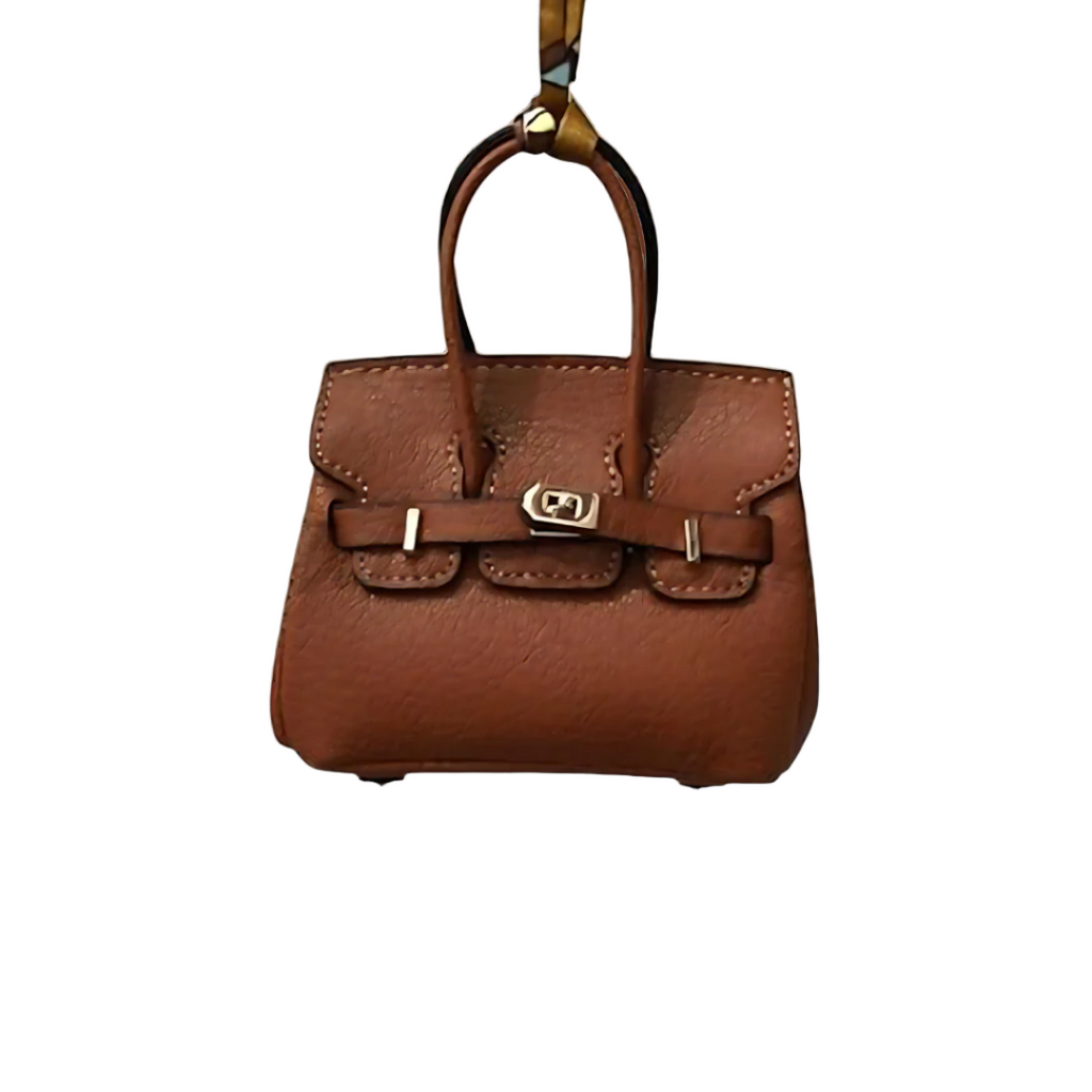 Brown genuine leather Mini Purse Iconic Bag Charm with structured shape, top handle, securing straps, and gold-tone padlock.