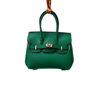 Green genuine leather Mini Purse Iconic Bag Charm with structured shape, top handle, securing straps, and gold-tone padlock.