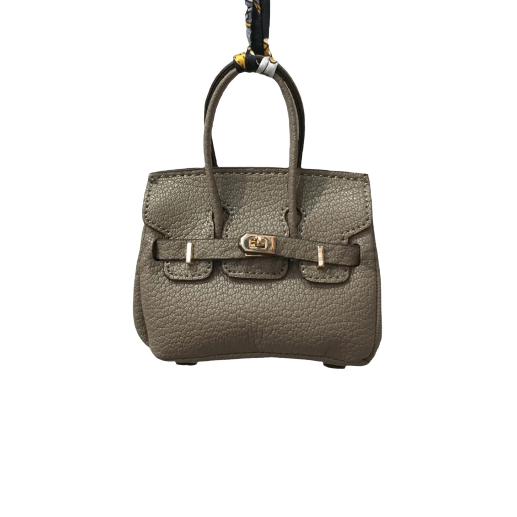 Khaki genuine leather Mini Purse Iconic Bag Charm with structured shape, top handle, securing straps, and gold-tone padlock.