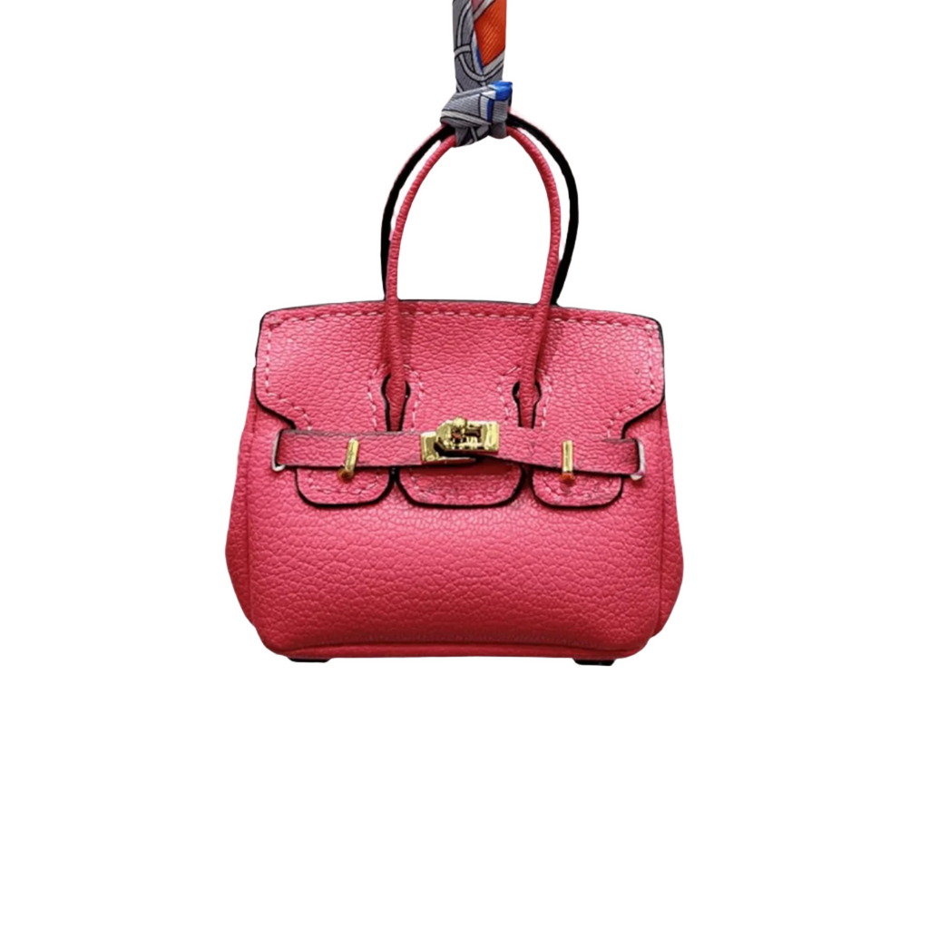 Pink genuine leather Mini Purse Iconic Bag Charm with structured shape, top handle, securing straps, and gold-tone padlock.