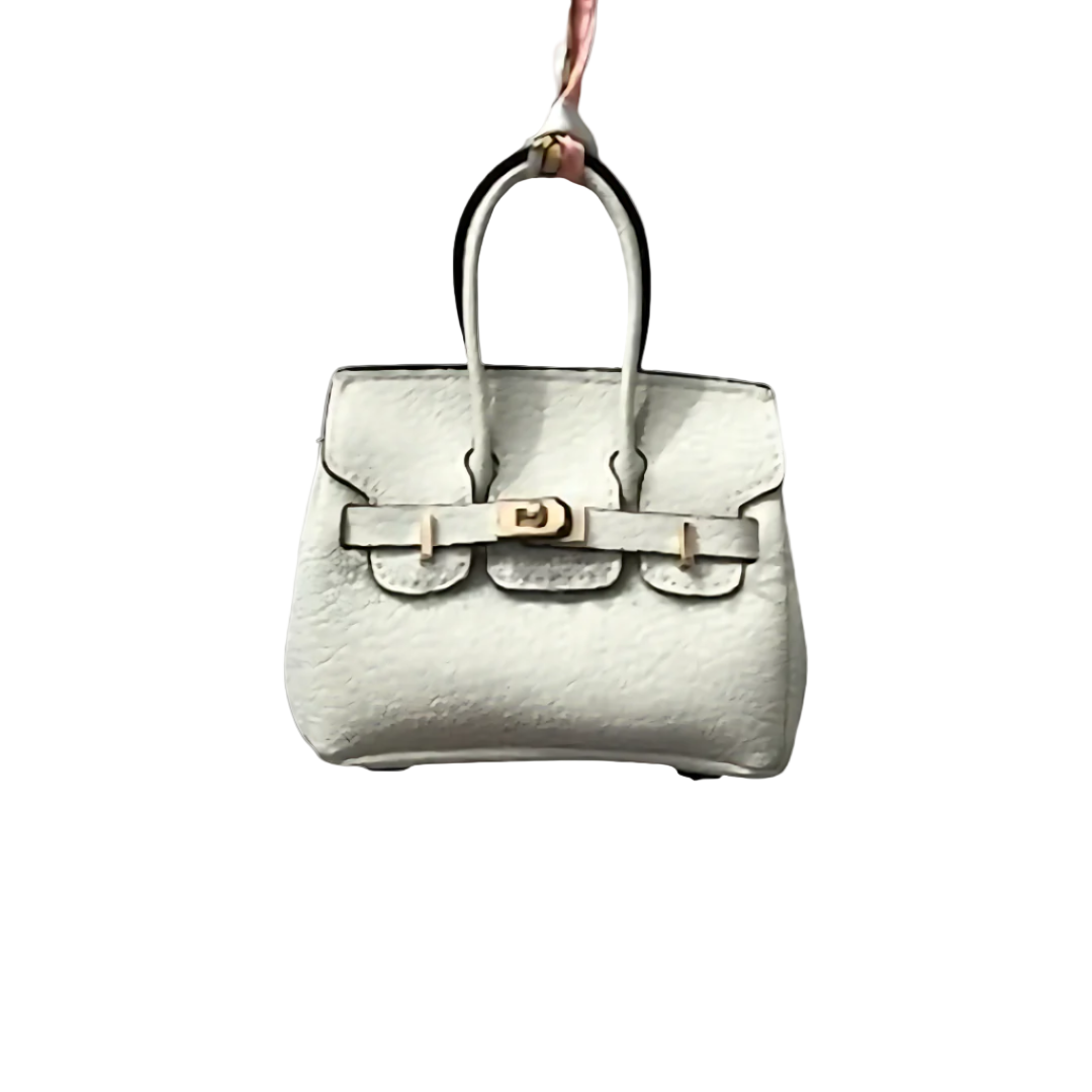 White genuine leather Mini Purse Iconic Bag Charm with structured shape, top handle, securing straps, and gold-tone padlock.