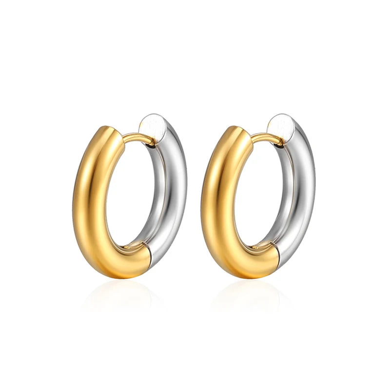 Pair of gold and silver hoop earrings on a white background