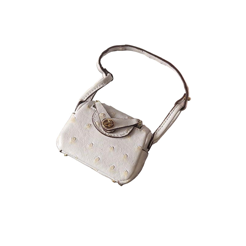 White Ostrich textured mini bag charm with flap closure and small shoulder strap.