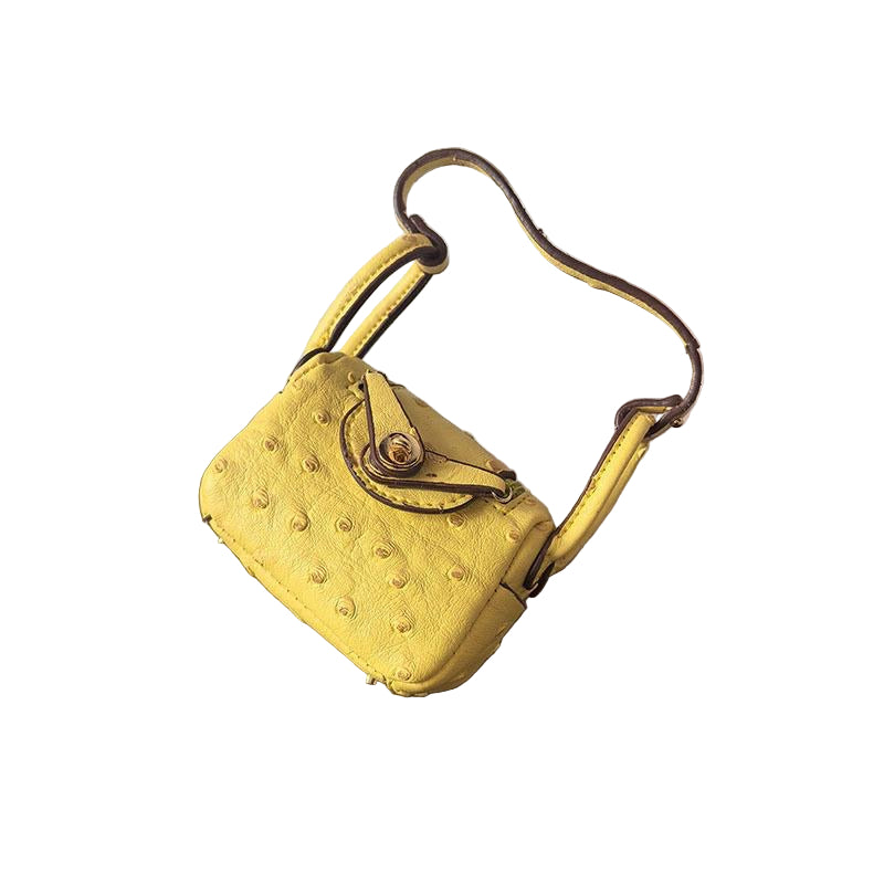 Yellow Ostrich textured mini bag charm with flap closure and small shoulder strap.