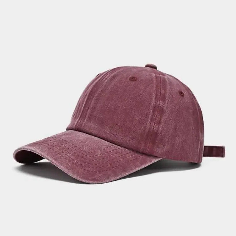 Purple baseball cap on a light gray background