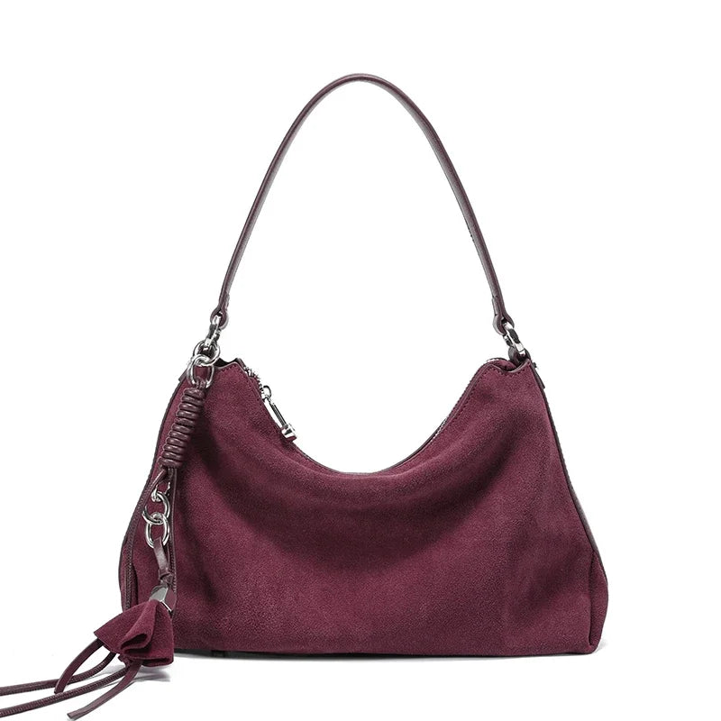 Purple handbag with a strap on a white background