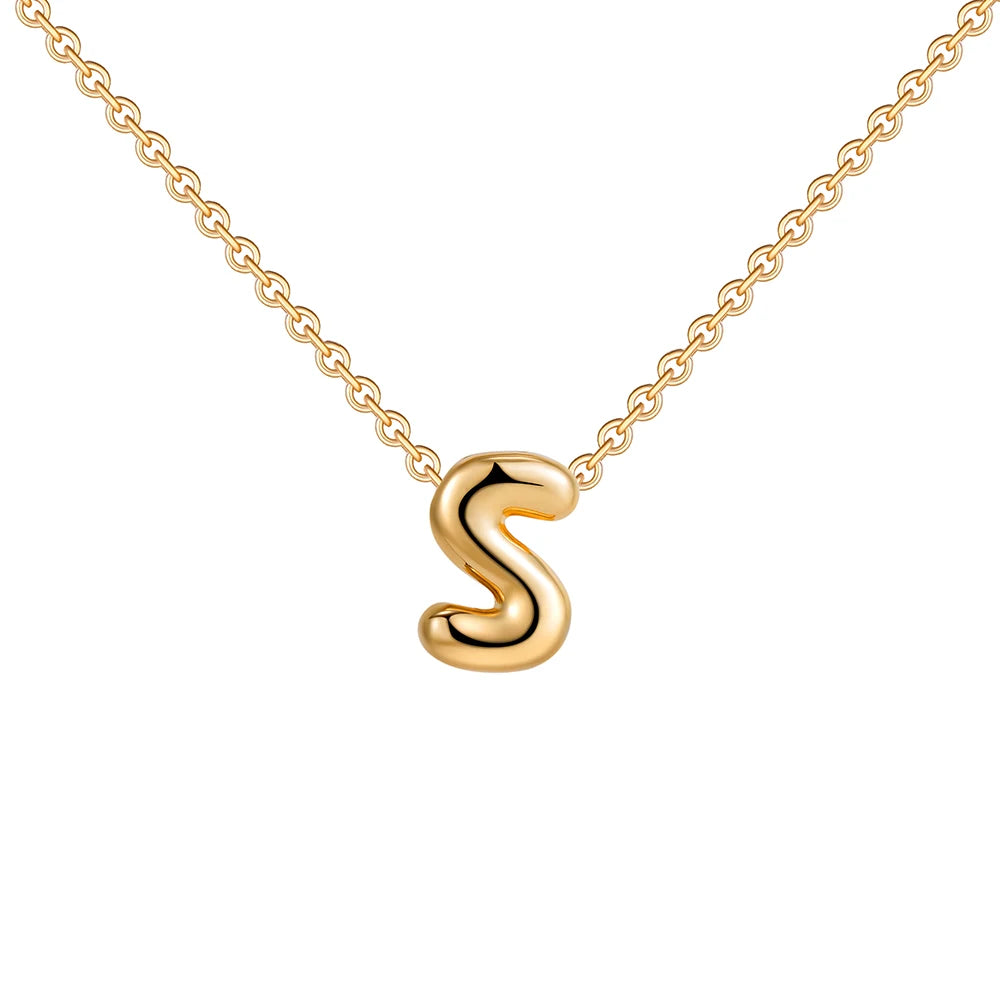 Gold necklace with a 'S' pendant on a white background
