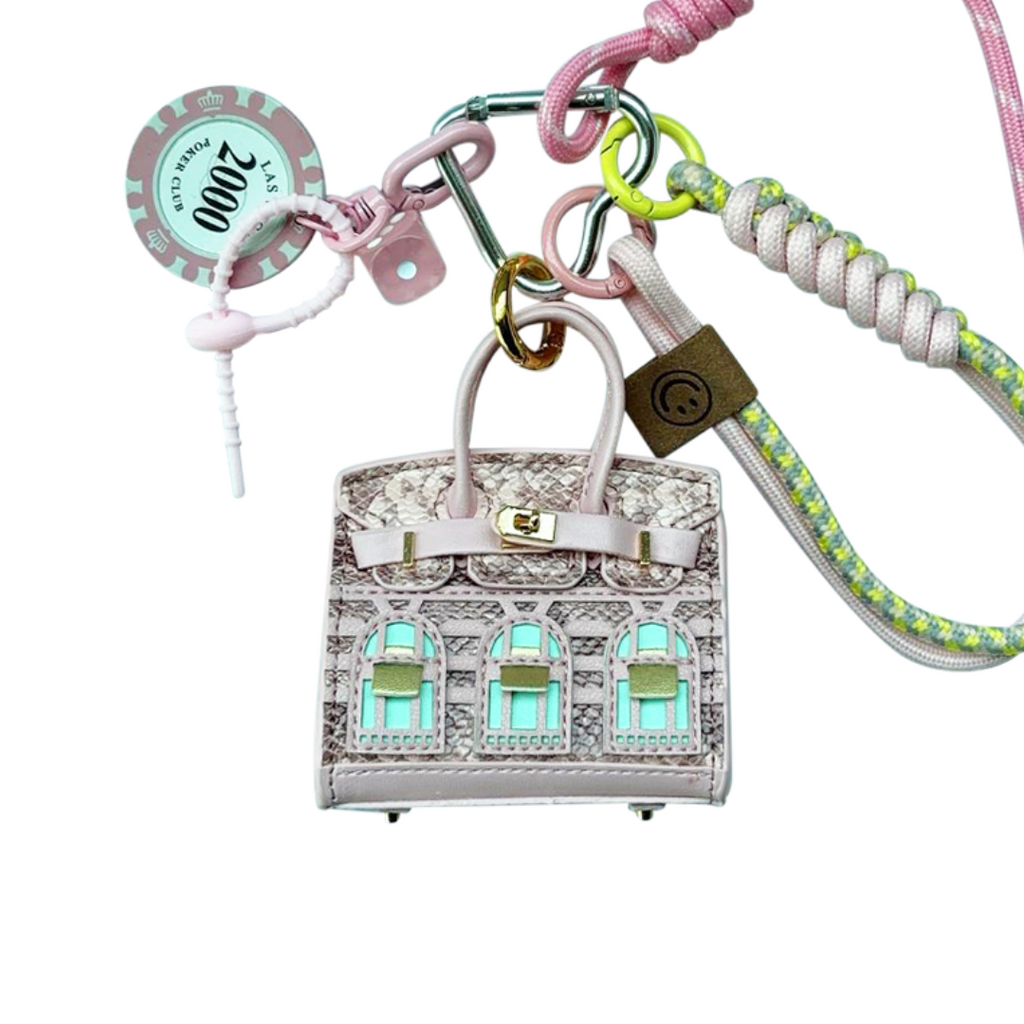 Salmon pink snakeskin leather mini bag charm with keychain shaped like a house, featuring window panels and a top handle.