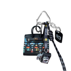 Black glass stained structured mini bag charm shaped like a house, featuring decorative window panels and a top handle.