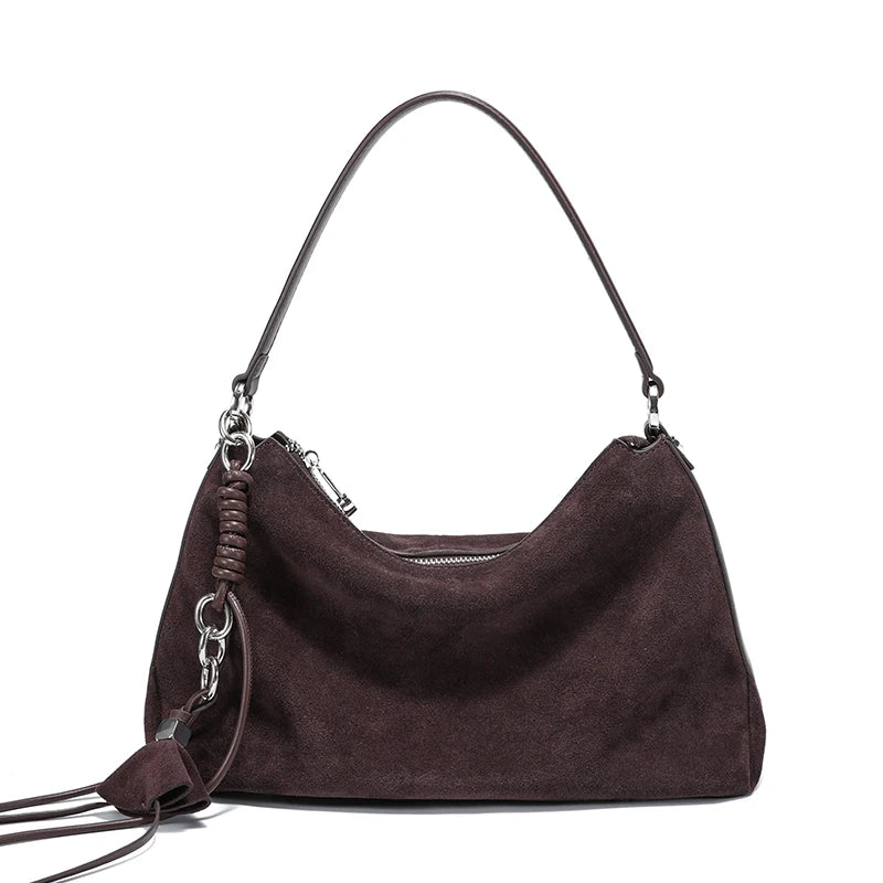 Brown handbag with a strap on a white background
