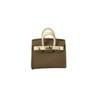 Khaki and creme genuine leather structured bag charm with top handle, flap closure, securing straps, and gold-tone padlock hardware.