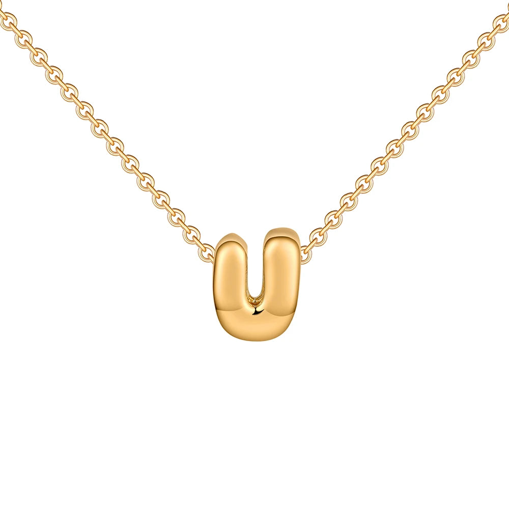 Gold necklace with a U-shaped pendant on a white background