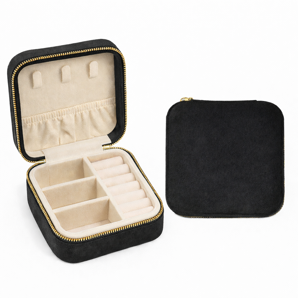 Black jewelry case with beige interior, open to show compartments on a white background