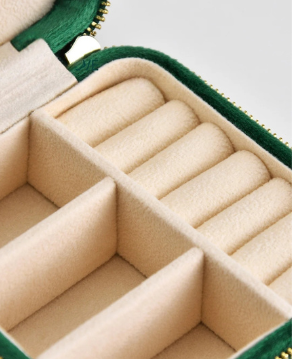 Green jewelry case with beige interior compartments