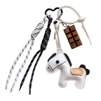 Keychain with horse charm and braided lanyard on a newspaper background